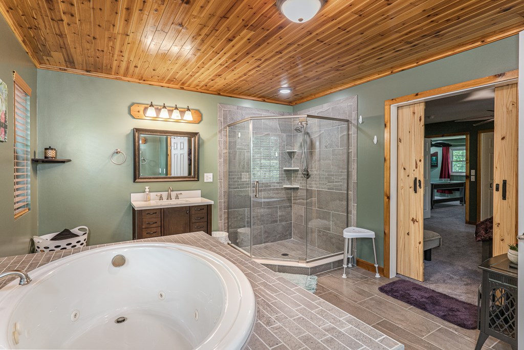 140 Kathryn Circle Murphy, NC 28906 - Photo 30 of 55 a spacious bathroom with a tub a sink and glass door shower