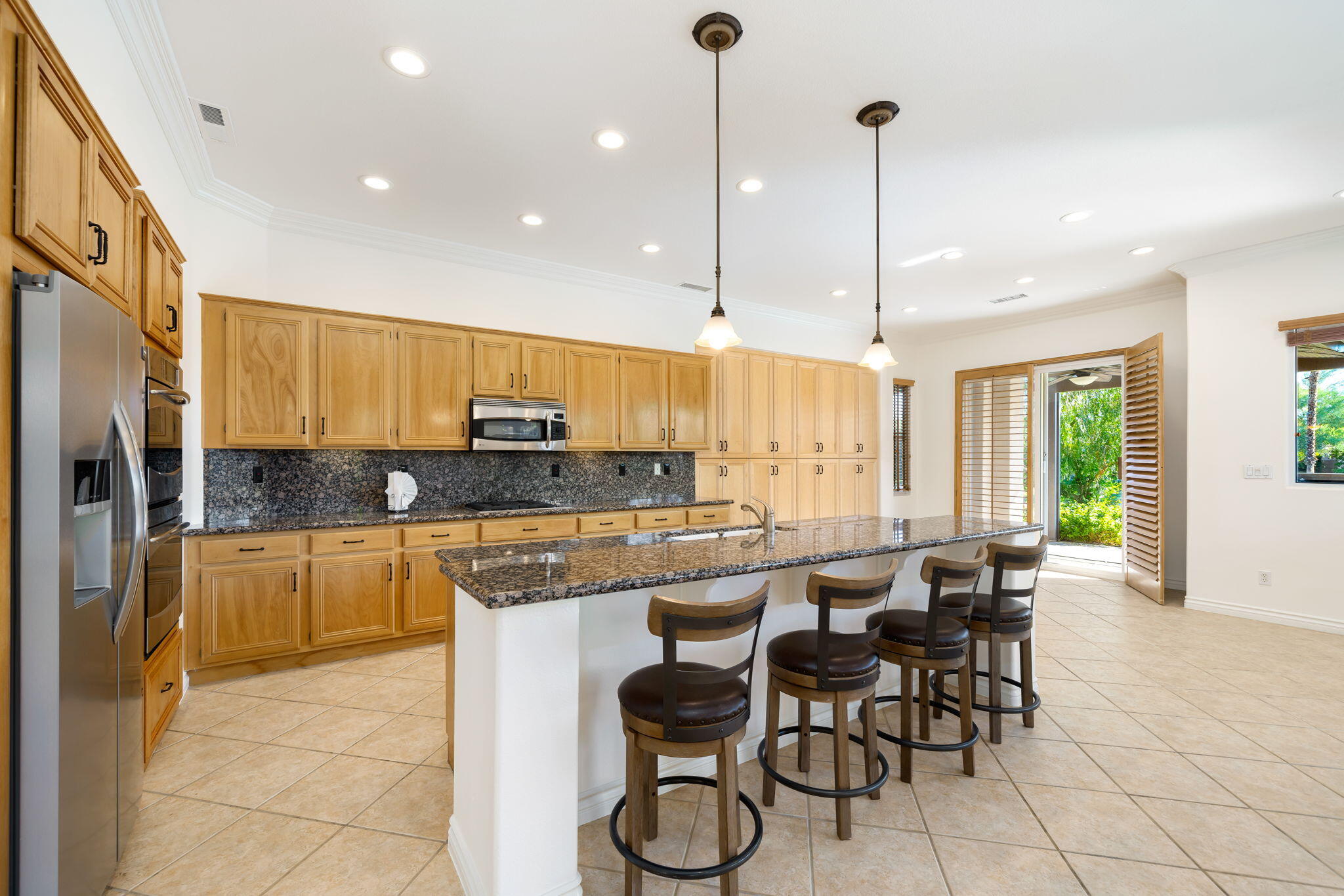 27 Racquet Club Drive South Rancho Mirage, CA 92270 - Photo 15 of 44 a kitchen with stainless steel appliances granite countertop counter space a sink and cabinets