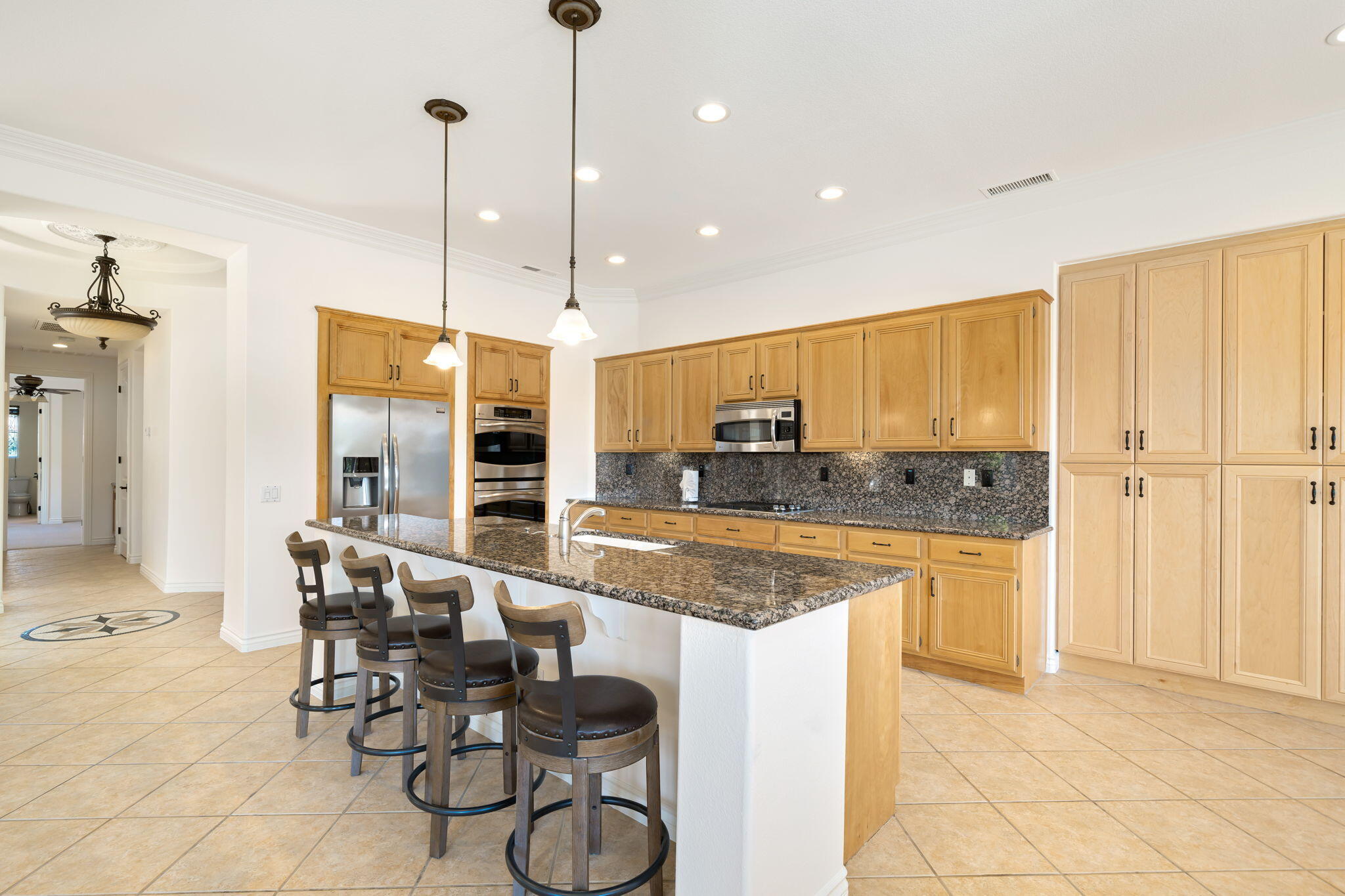 27 Racquet Club Drive South Rancho Mirage, CA 92270 - Photo 16 of 44 a kitchen with stainless steel appliances granite countertop a stove a sink and a refrigerator