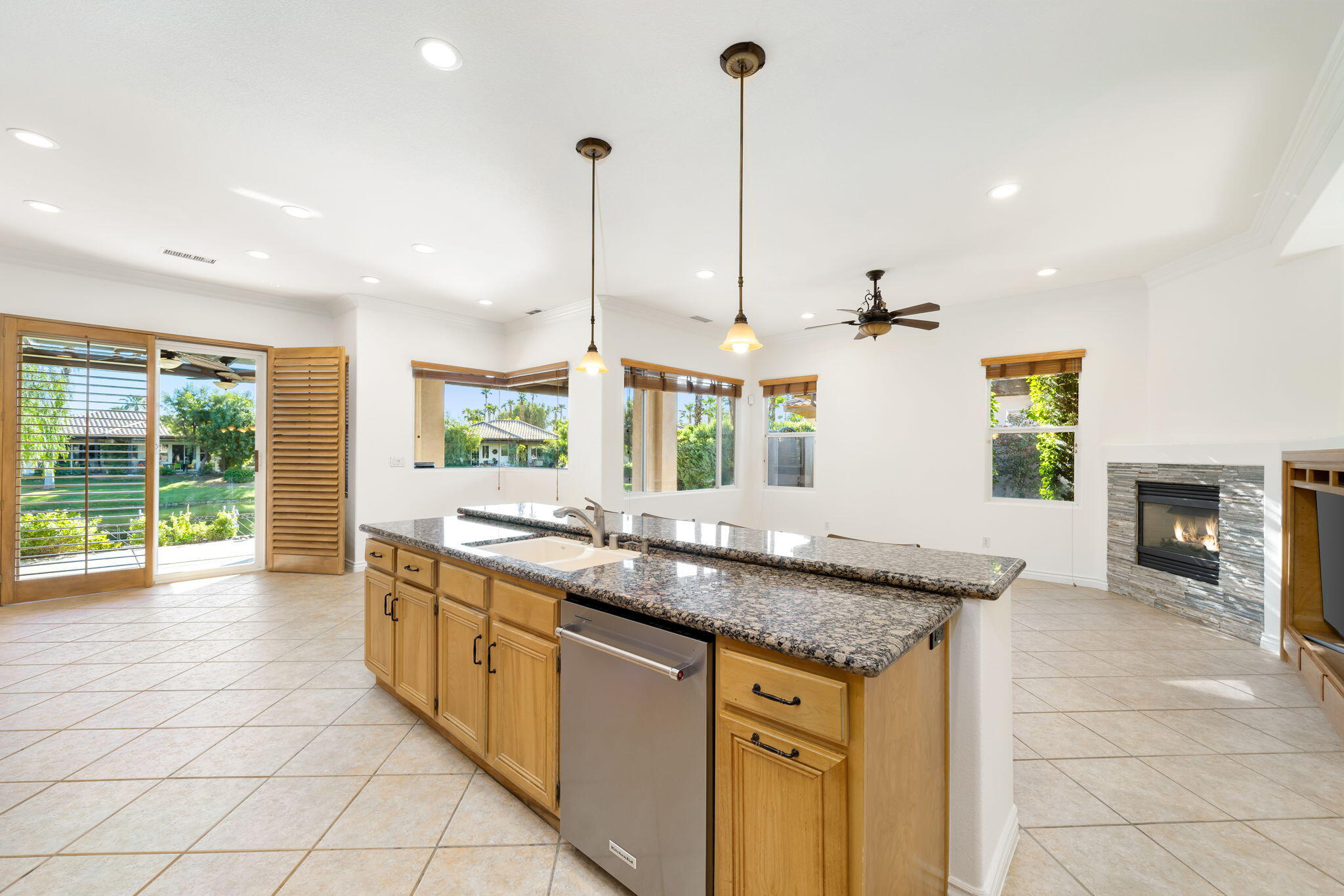 27 Racquet Club Drive South Rancho Mirage, CA 92270 - Photo 18 of 44 a kitchen with stainless steel appliances granite countertop a sink a counter space and a view of living room
