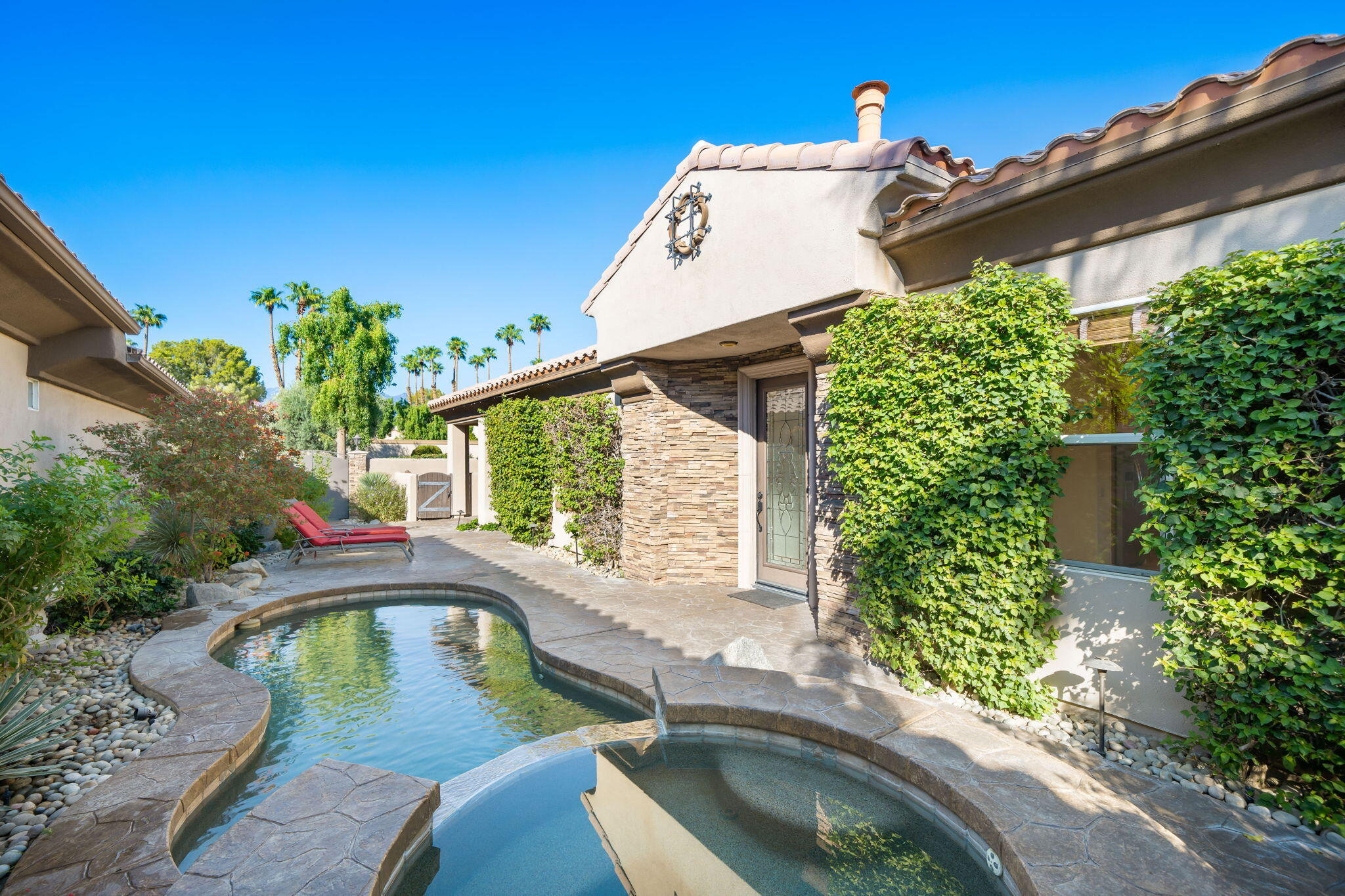 27 Racquet Club Drive South Rancho Mirage, CA 92270 - Photo 2 of 44 a house view with a swimming pool and outdoor space