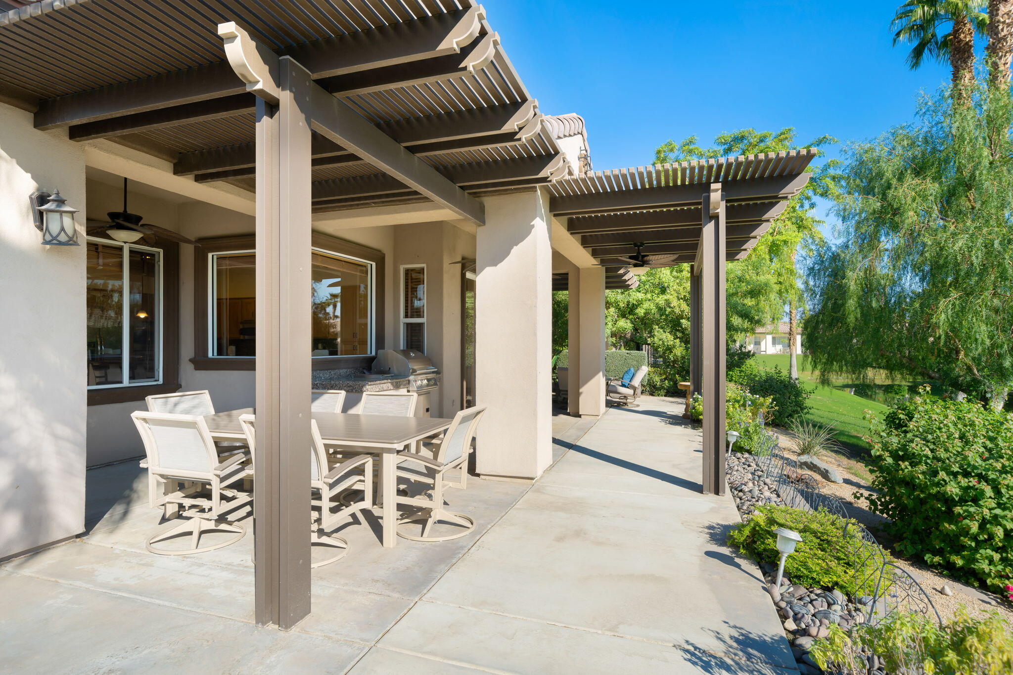 27 Racquet Club Drive South Rancho Mirage, CA 92270 - Photo 26 of 44 a patio with yard glass top table and chairs