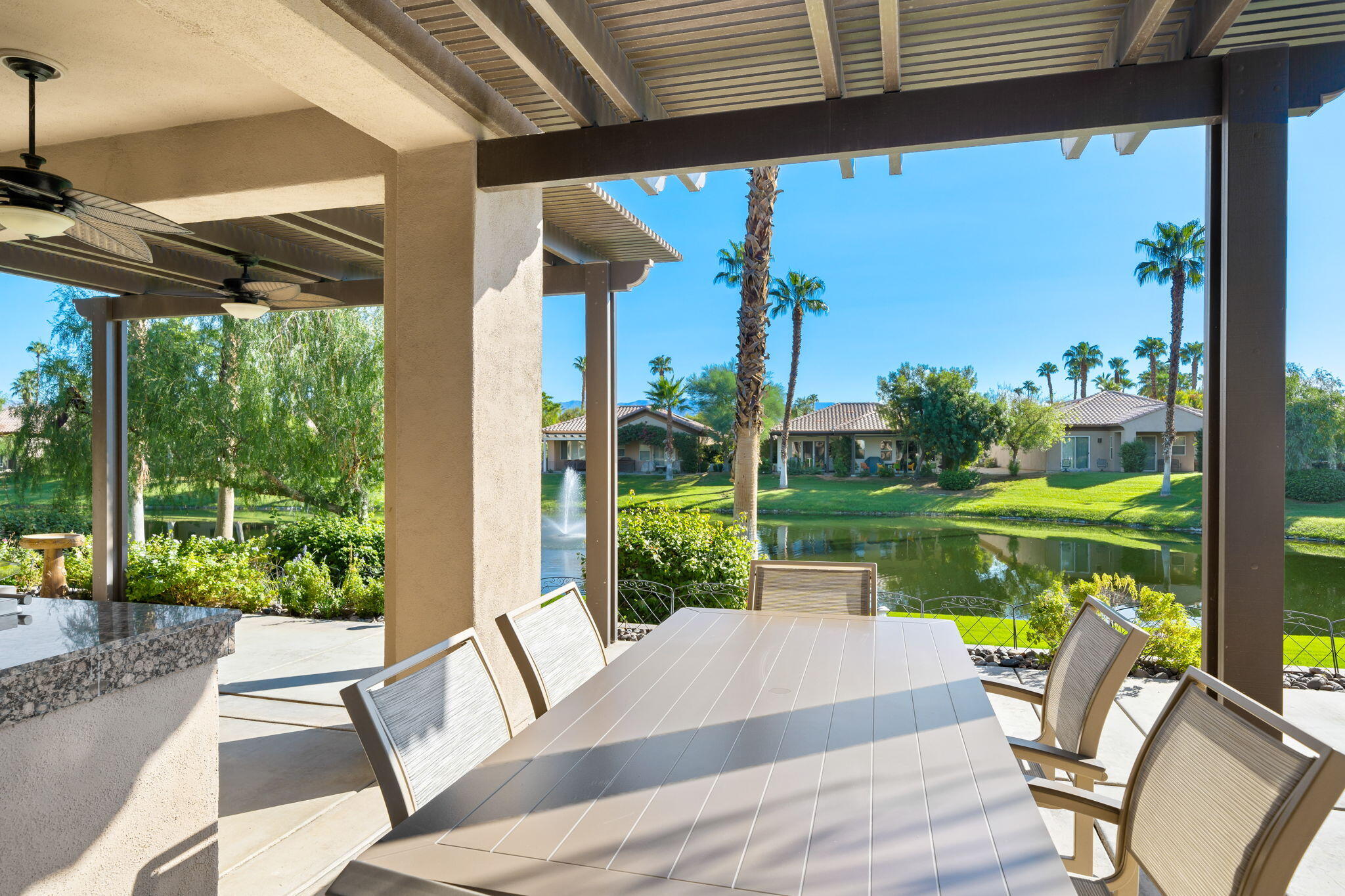 27 Racquet Club Drive South Rancho Mirage, CA 92270 - Photo 27 of 44 a patio with table and chairs and potted plants