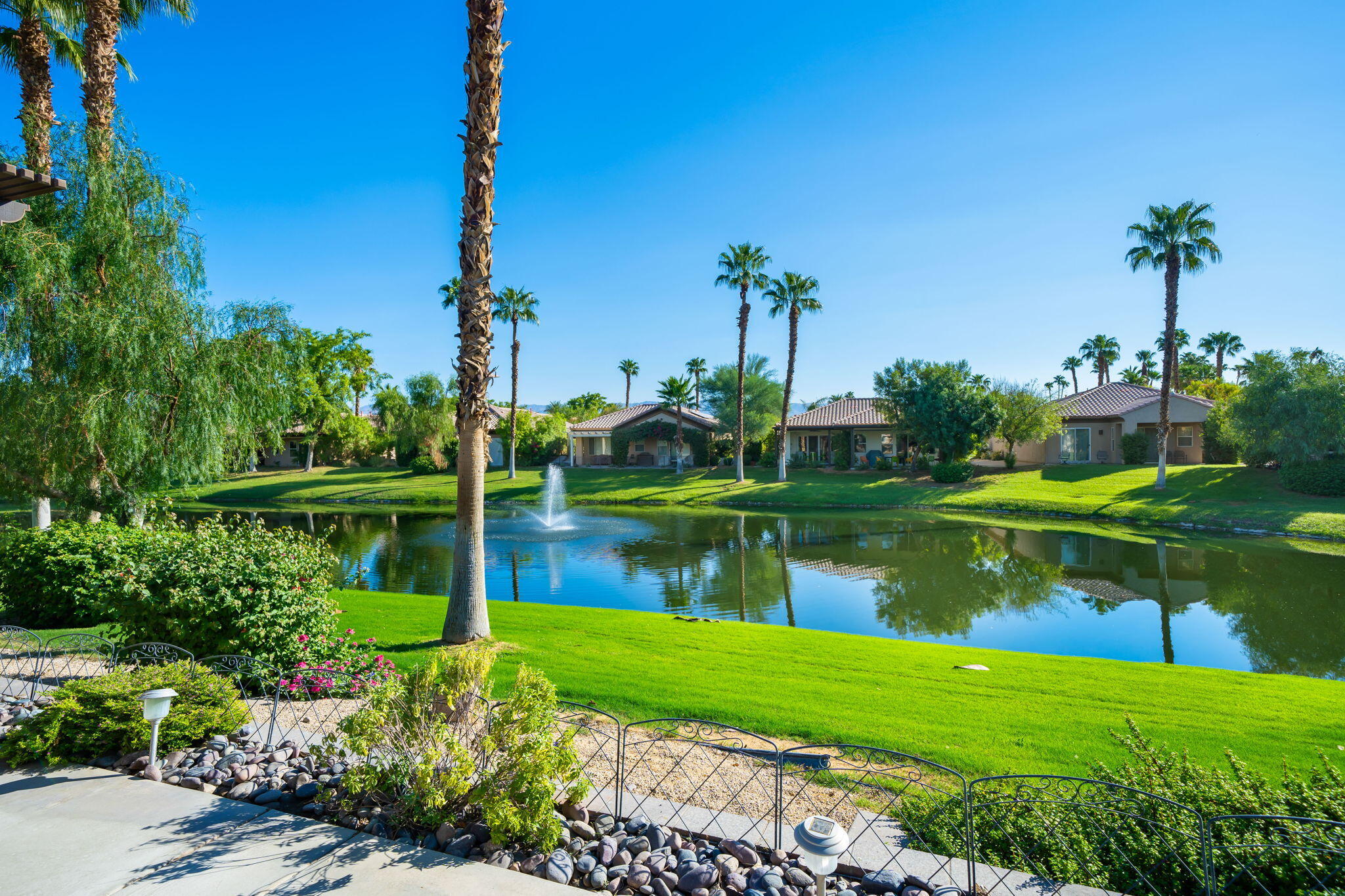 27 Racquet Club Drive South Rancho Mirage, CA 92270 - Photo 28 of 44 a view of a lake with a house in the background