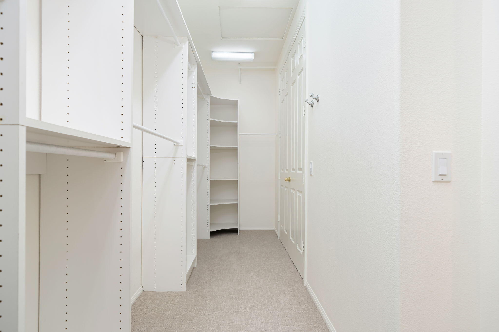 27 Racquet Club Drive South Rancho Mirage, CA 92270 - Photo 37 of 44 a view of a hallway with closet and a bathroom