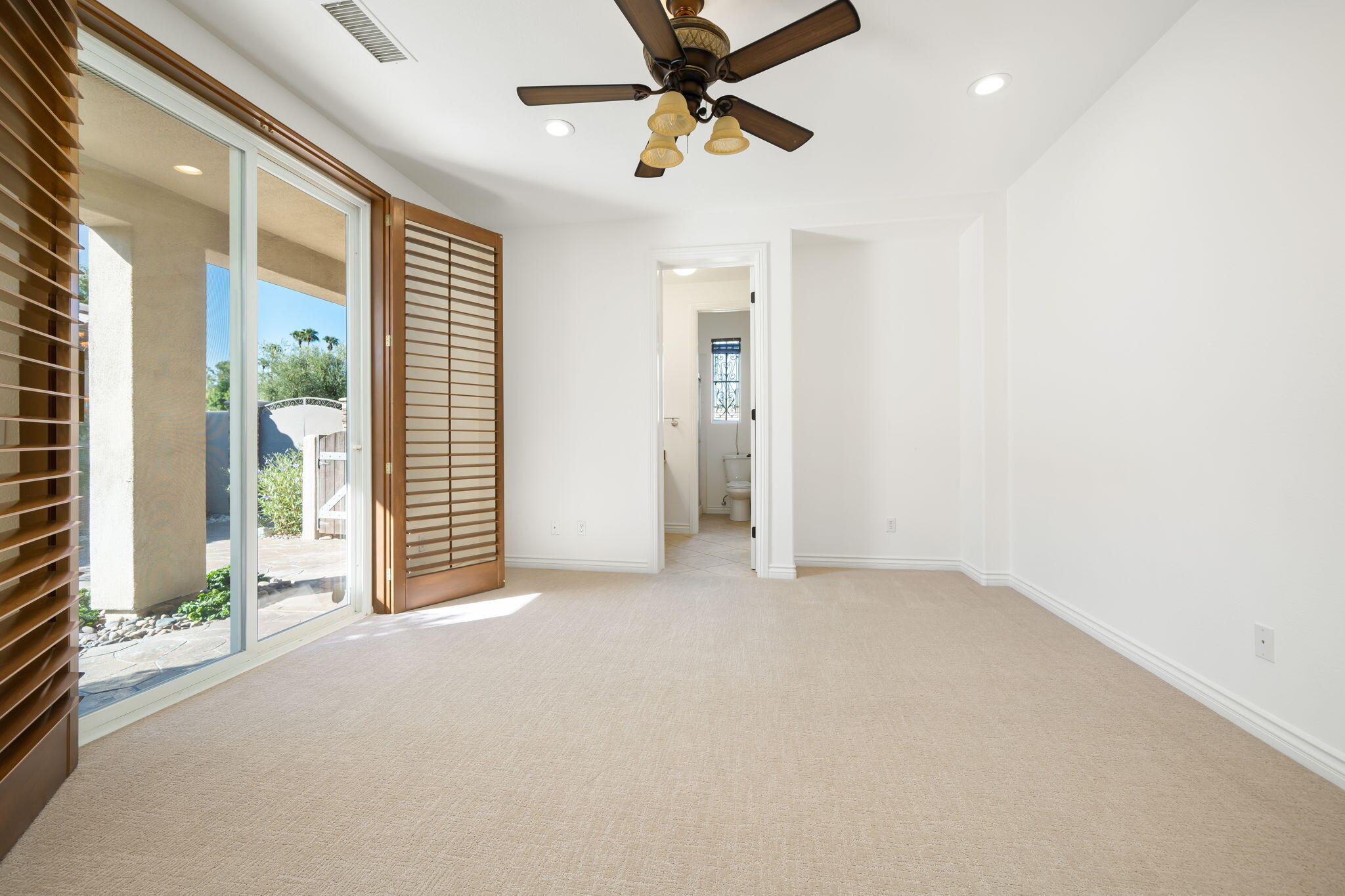 27 Racquet Club Drive South Rancho Mirage, CA 92270 - Photo 38 of 44 en empty room with windows and ceiling fan