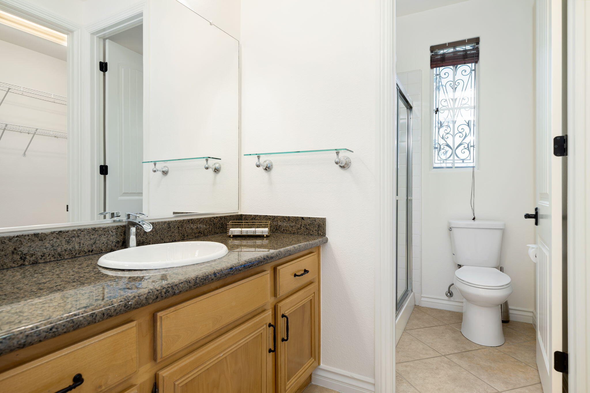 27 Racquet Club Drive South Rancho Mirage, CA 92270 - Photo 40 of 44 a bathroom with a granite countertop sink a toilet and a mirror