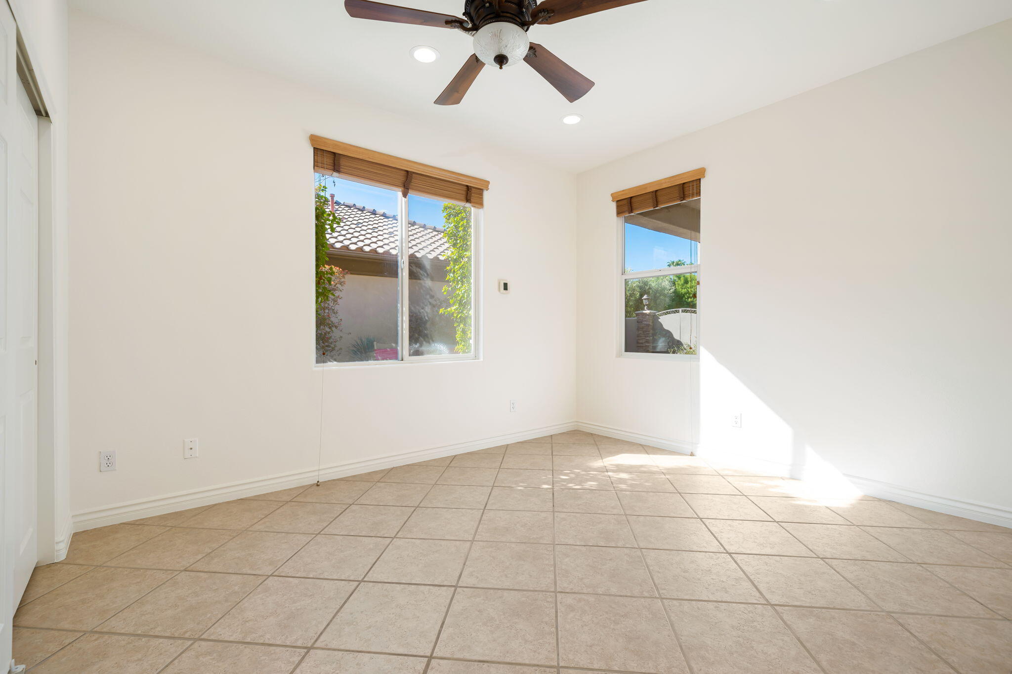27 Racquet Club Drive South Rancho Mirage, CA 92270 - Photo 41 of 44 an empty room with a ceiling fan and a window