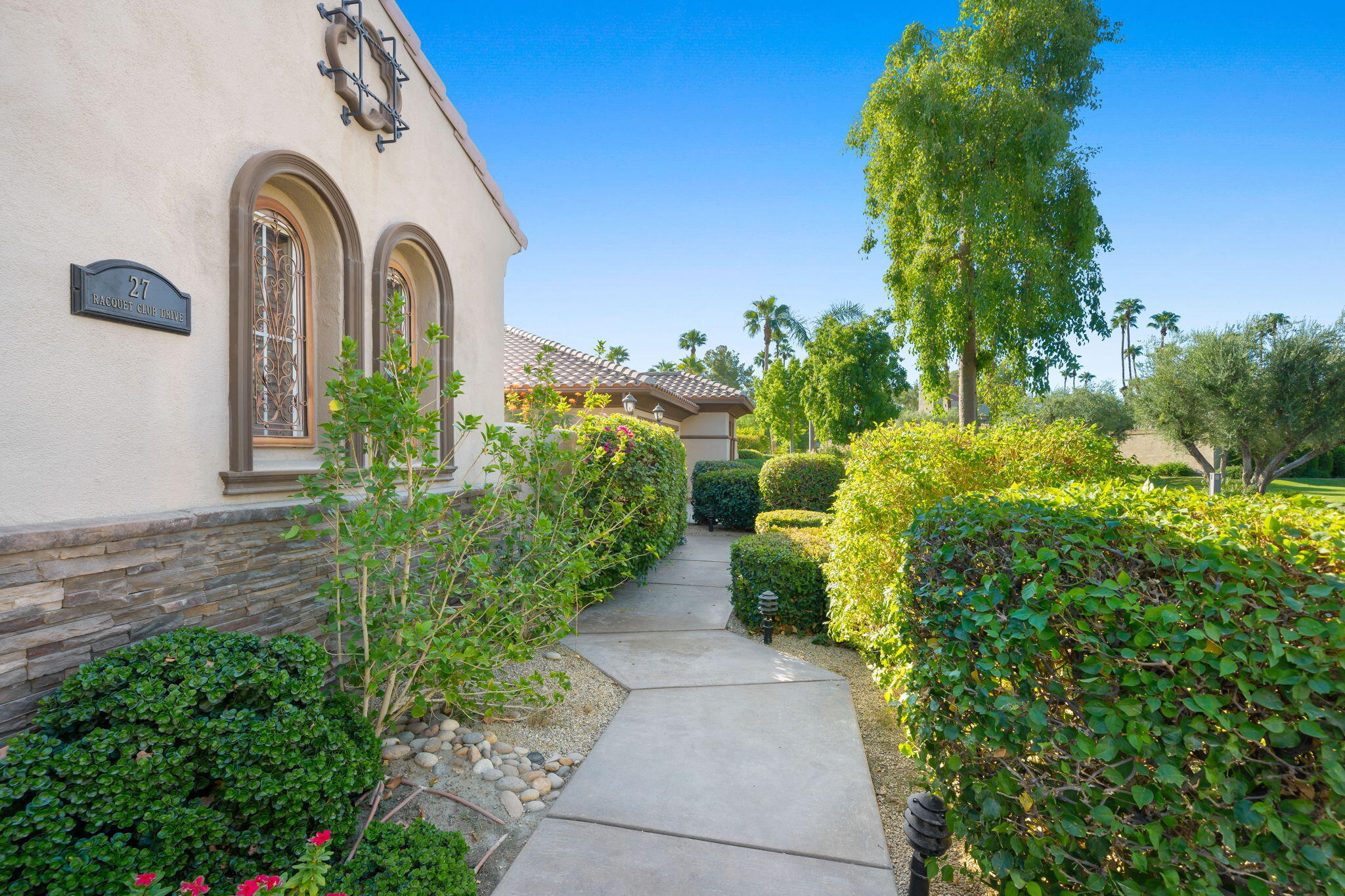 27 Racquet Club Drive South Rancho Mirage, CA 92270 - Photo 7 of 44 a front view of a house with garden
