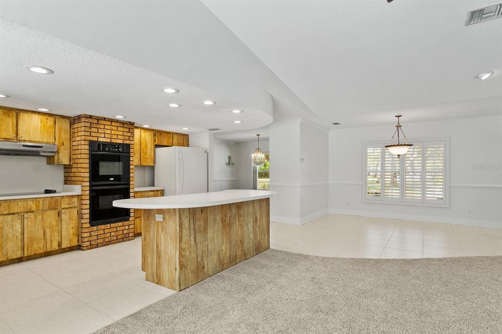 10206 Lakeview Drive New Port Richey, FL 34654 - Photo 11 of 53 a view of kitchen with kitchen island stainless steel appliances a sink counter space and a window