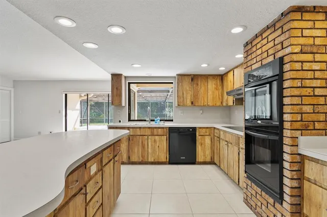 a open kitchen with a sink and refrigerator
