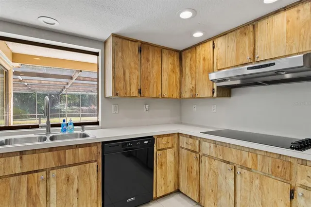 a spacious bathroom with a granite countertop sink a toilet a mirror and shower