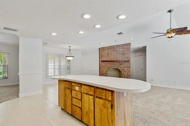 a view of an empty room with window and cabinet