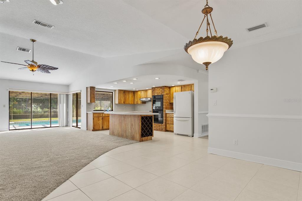 10206 Lakeview Drive New Port Richey, FL 34654 - Photo 20 of 53 a view of a room with shelves and chandelier