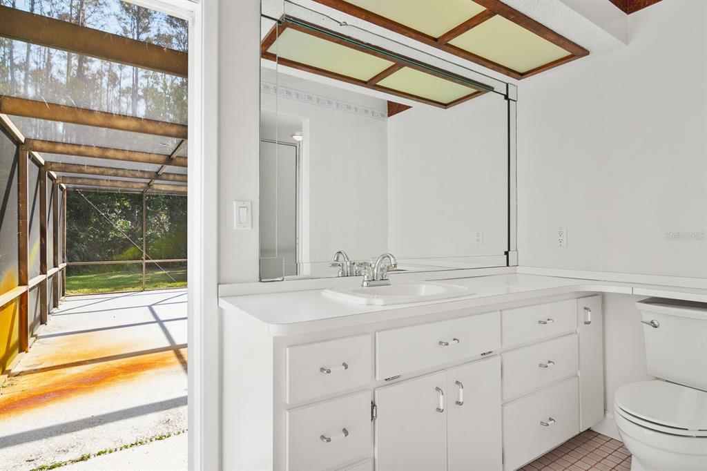 10206 Lakeview Drive New Port Richey, FL 34654 - Photo 33 of 53 a bathroom with a sink and a mirror next to a window