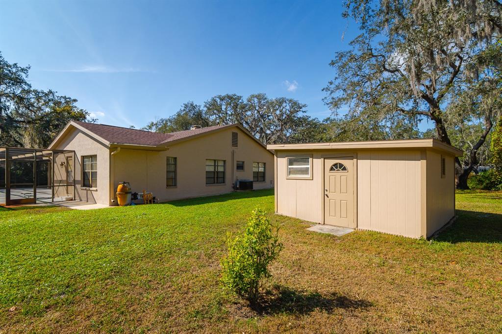 10206 Lakeview Drive New Port Richey, FL 34654 - Photo 46 of 53 a front view of house with yard and trees in the background