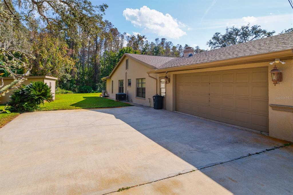 10206 Lakeview Drive New Port Richey, FL 34654 - Photo 48 of 53 a view of a house with a yard and garage