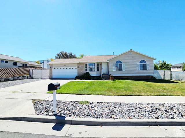 3192 South 8105 West Magna, UT 84044 - Photo 1 of 1 View of front of home with driveway, an attached garage, and brick siding