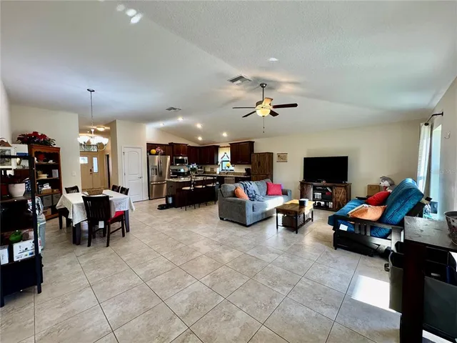 a dining room with furniture and a book shelf