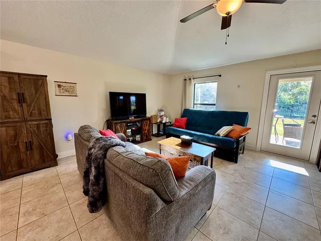 a spacious bedroom with a bed couch and a window