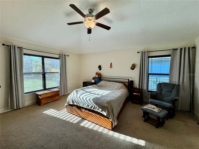 a bedroom with furniture and a flat screen tv