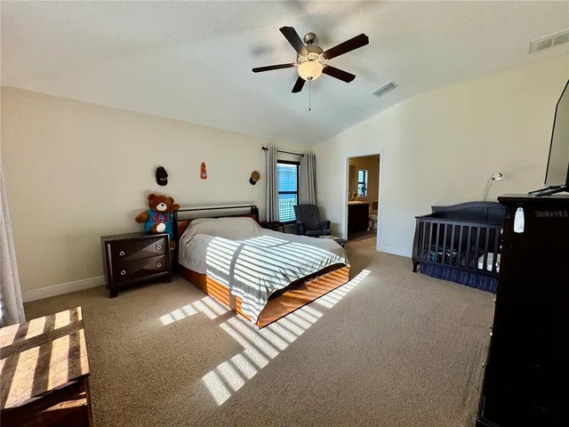 a bathroom with a granite countertop sink toilet and a mirror