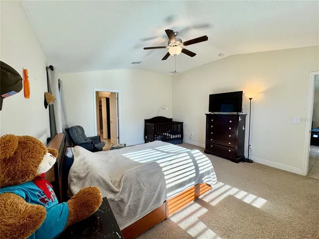 a bathroom with a granite countertop sink a mirror and shower