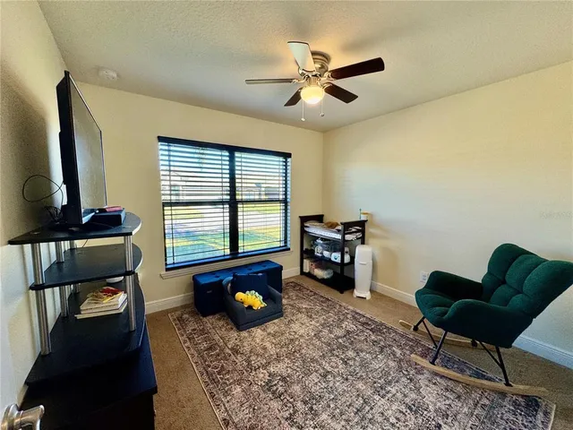 a living room with furniture and a piano