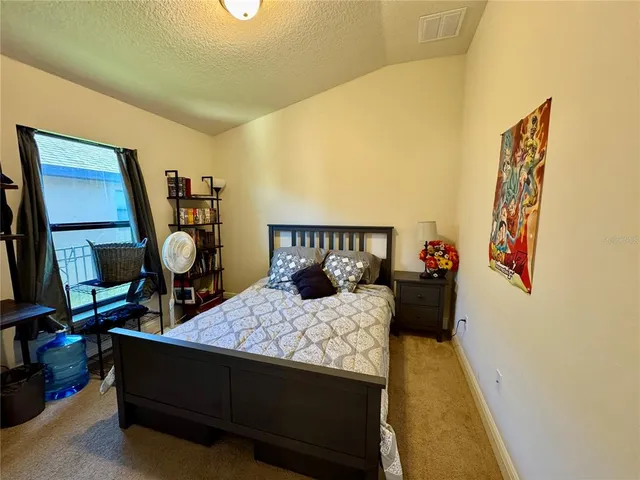 a bedroom with a bed and a table in it