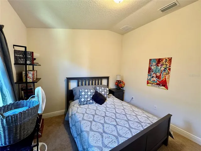 a backyard of a house with lots of green space and outdoor seating