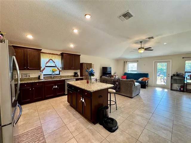 a view of a dining room kitchen and a chandelier