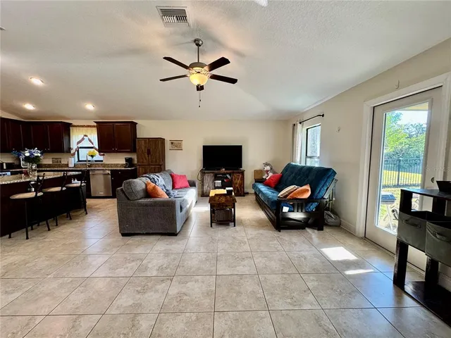 a living room with lots of furniture and a flat screen tv