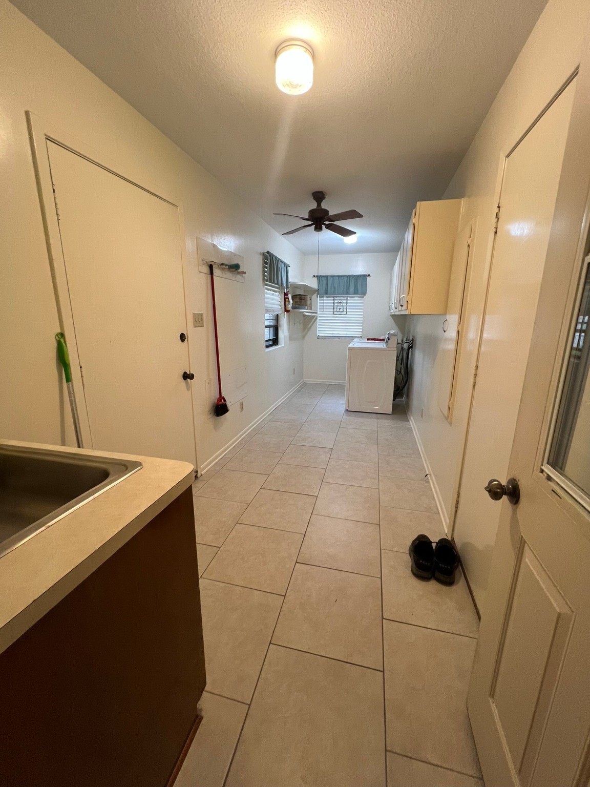 507 North Rusk Street Wharton, TX 77488 - Photo 13 of 18 a kitchen with a sink a refrigerator and cabinets