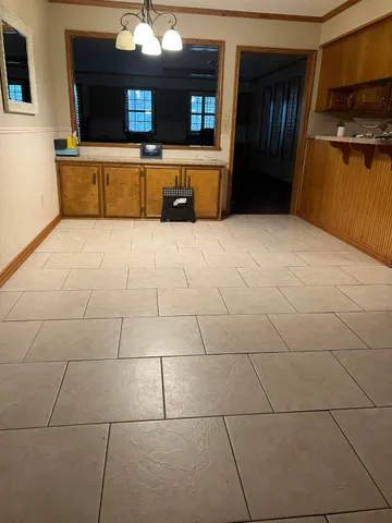 a kitchen with granite countertop a sink a stove and cabinets