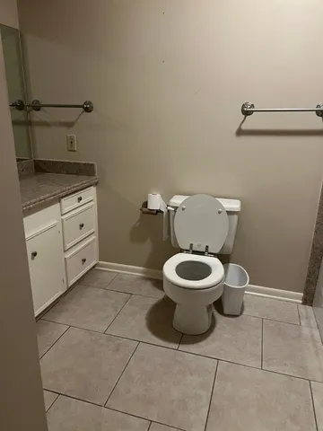 a white toilet sitting next to a bathroom sink
