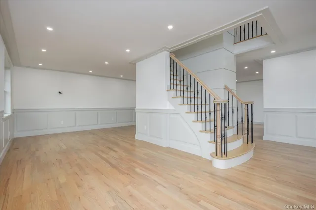 a large white kitchen with a refrigerator and a stove top oven