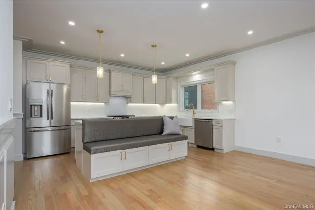 a kitchen with granite countertop a sink stainless steel appliances and cabinets