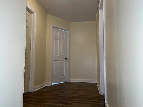 a room with a bench and wooden floor