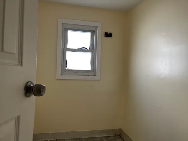 a view of room with hardwood floor and window