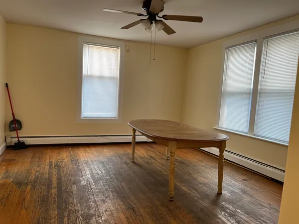 a view of an empty room with wooden floor