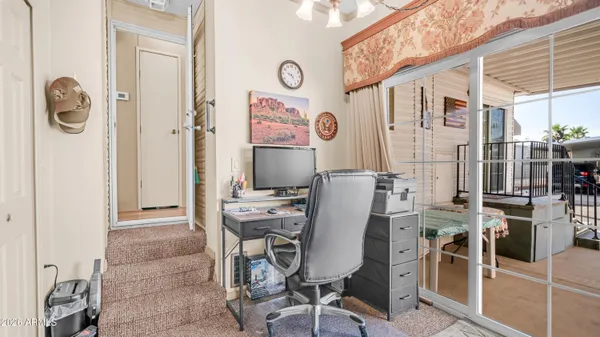 a view of a balcony with chairs and couches with wooden floor