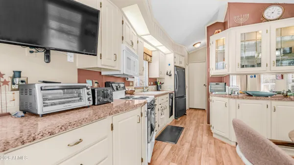 a kitchen with stainless steel appliances granite countertop a sink and a refrigerator