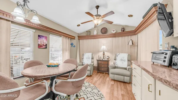 a kitchen with stainless steel appliances dining table and chairs