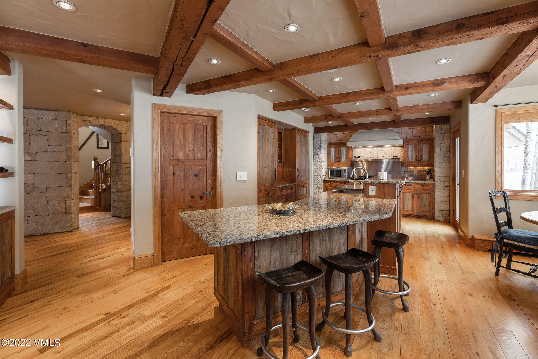 106 Pilgrim Drive Edwards, CO 81632 - Photo 6 of 21 a dining hall with stainless steel appliances kitchen island granite countertop wooden floor a dining table and chairs