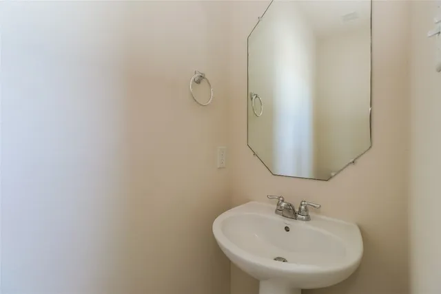 a bathroom with a sink and mirror