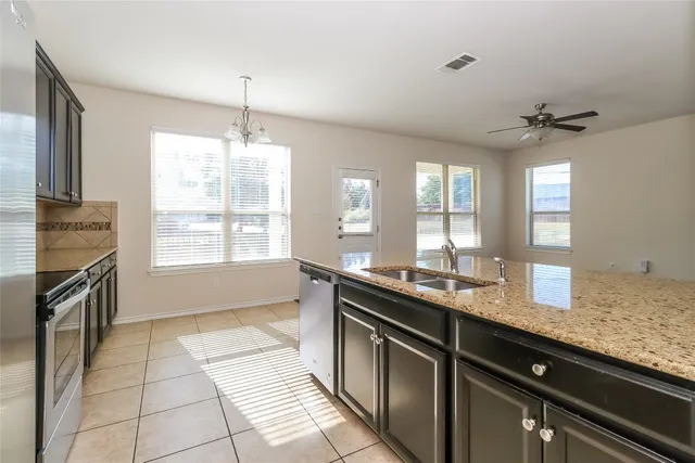a kitchen with a sink stove and cabinets