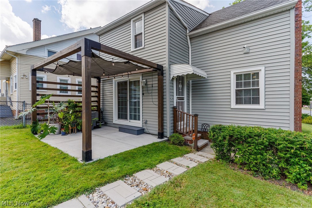 3625 Ludgate Road Cleveland, OH 44120 - Photo 14 of 16 Rear view of house with a pergola, a lawn, and a patio