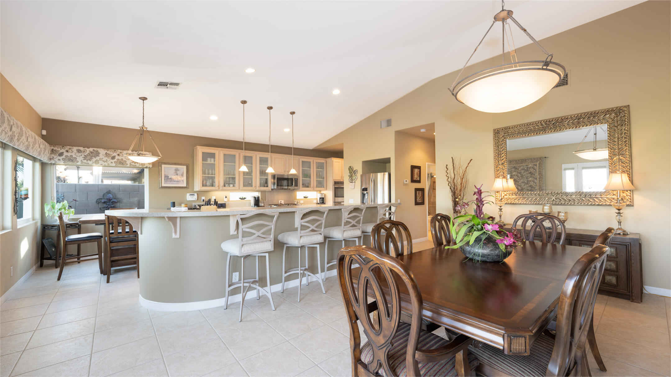 80290 Pebble Beach Drive Indio, CA 92201 - Photo 11 of 44 a kitchen with a dining table chairs wooden floor and appliances
