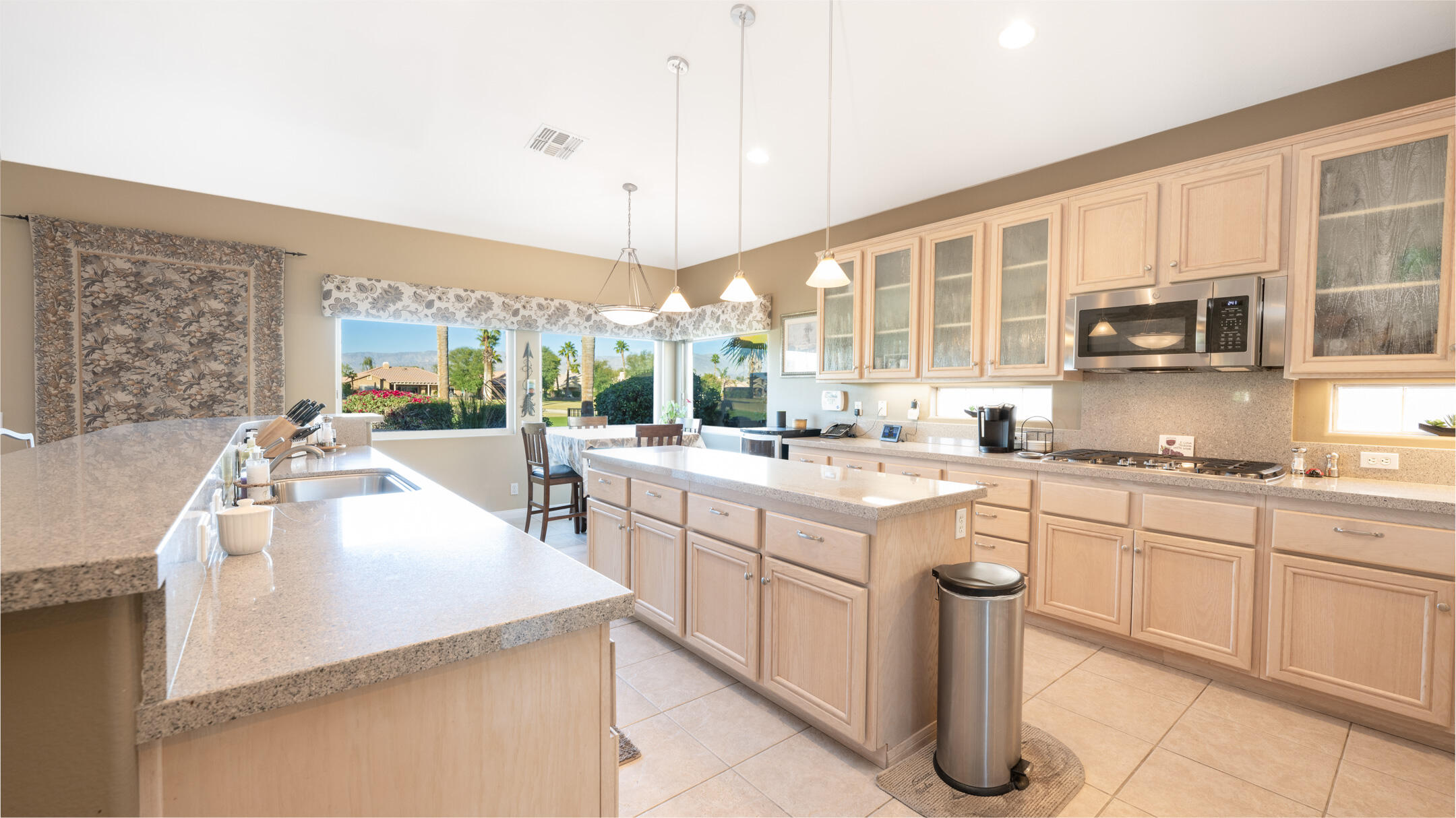 80290 Pebble Beach Drive Indio, CA 92201 - Photo 12 of 44 a open kitchen with stainless steel appliances granite countertop a sink and cabinets