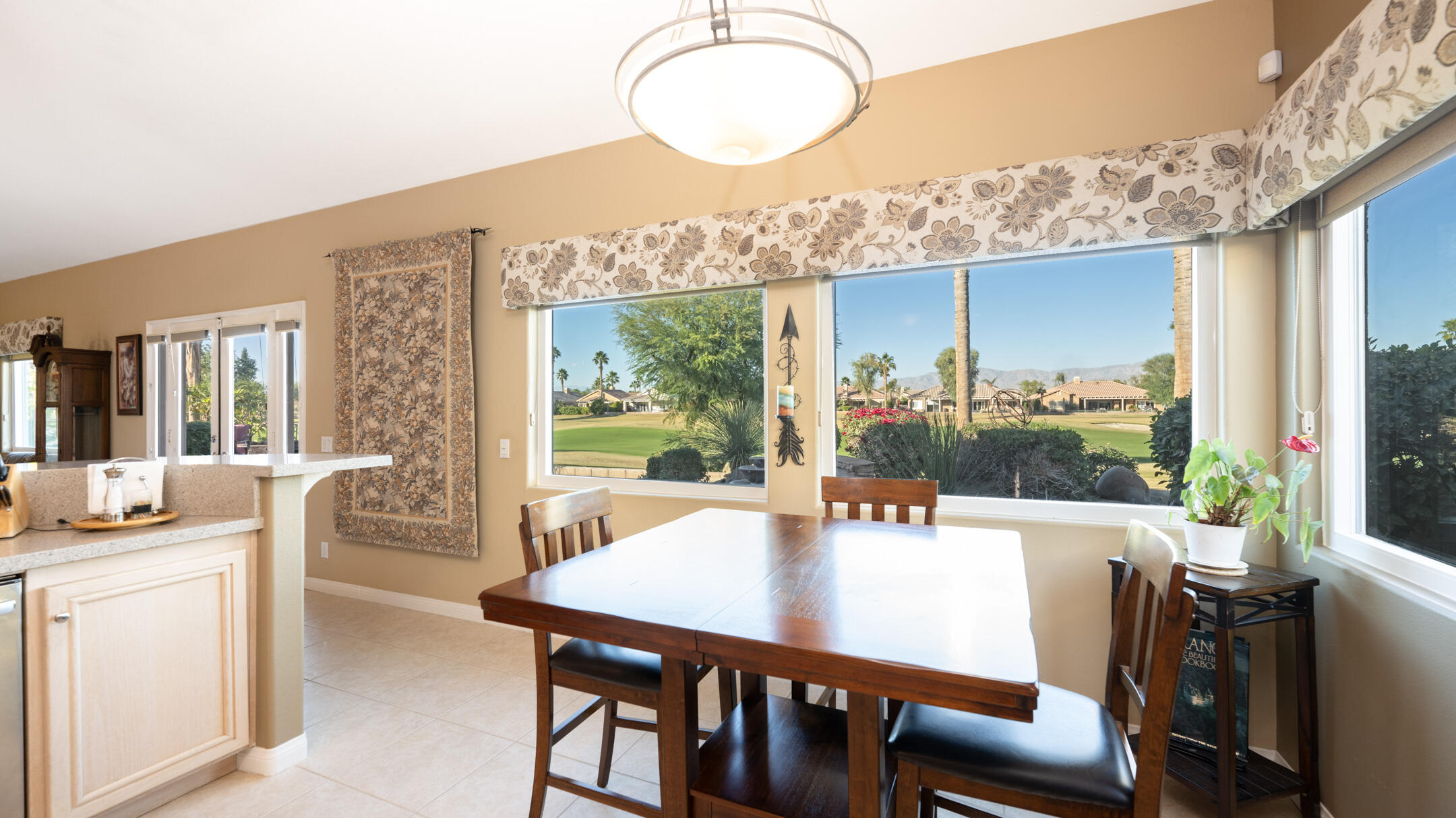 80290 Pebble Beach Drive Indio, CA 92201 - Photo 13 of 44 a view of a dining room with furniture window and wooden floor
